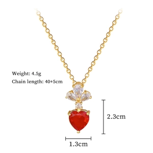 Detail of gold necklace with red heart stone and crystal flower with dimensions