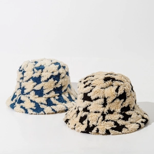 Detailed macro view showing the thick houndstooth plush texture of winter bucket hats