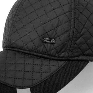 Detail of black quilted winter hat with silver D-metal logo and warm knit visor textures