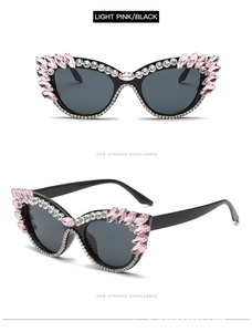 Detail of pink and black cat-eye sunglasses with sparkling rhinestones on the frame