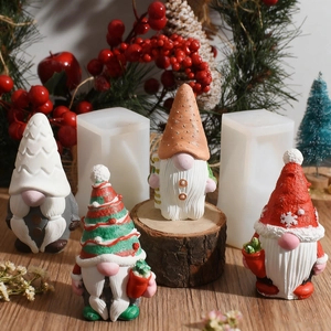 Detail of Christmas gnome silicone molds with hand-painted finished plaster ornaments
