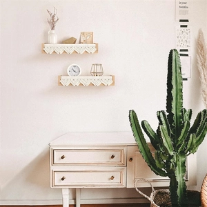 Solid wood wall shelf detail with delicate cream crochet lace trim in Nordic style