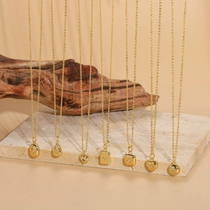 Macro shot of gold starburst necklaces with zircon pendants on stone and wood