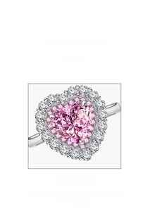 Macro view of heart-shaped pink gem ring with micro-pave diamond halo in silver