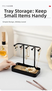 Close-up of black metal jewelry organizer with wooden tray for necklaces and rings