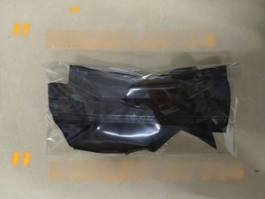 Macro detail of large satin bow hair clip in protective packaging weighing 26 grams