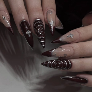 Gothic burgundy stiletto press-on nails with silver metal accents and cross charms