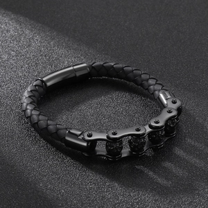 Detail of black woven leather men's bracelet with industrial metal links and magnetic clasp