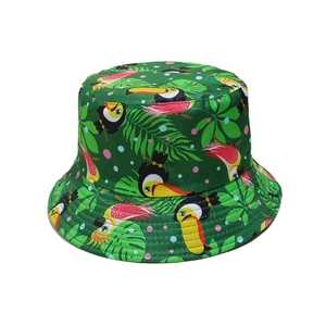 Green tropical bucket hat with toucan and palm leaf prints for summer beach trips