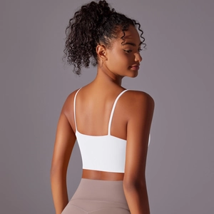 Rear view of white thin strap yoga top showing back muscle lines and U-shaped design