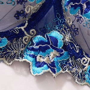 Close-up of deep blue floral lace embroidery on sheer mesh for a sexy lingerie set