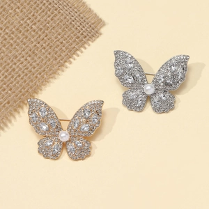 Elegant gold and silver alloy butterfly brooch with sparkling crystals and a center pearl
