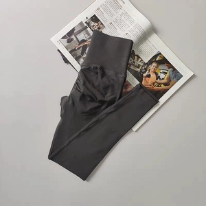 Detailed view of high-waisted dark grey yoga pants with ruched butt-lifting design