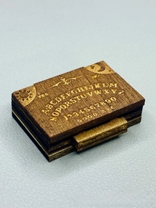 Detail of laser engraved vintage wooden spirit board box with sun and moon pattern
