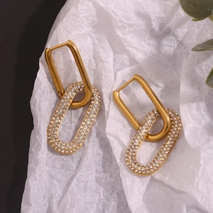 Detail showing high-quality 18K gold plated geometric earrings with micro-pave zircons