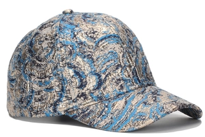 Close-up of blue and gold jacquard baseball cap showing metallic brocade texture