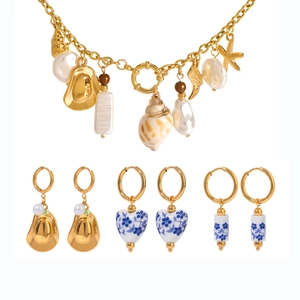 Golden stainless steel jewelry set with shell pendants and blue-white porcelain earrings