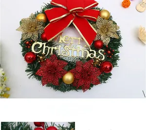 Close-up of Christmas wreath with red ribbon, golden bells and festive ornaments