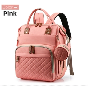 Pink multifunctional diaper backpack with quilted front pocket and round accessory pouch