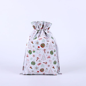 Close-up of Christmas drawstring gift bag with festive snowman and tree patterns