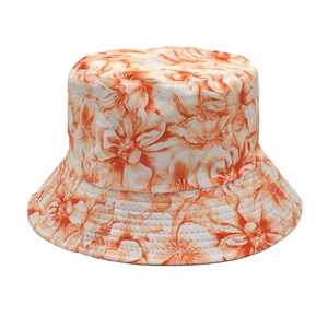 Detailed close-up of orange floral print on high-quality cotton summer bucket hat