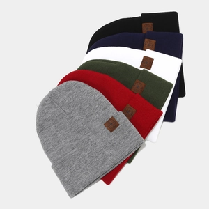 Variety of cuffed knit beanies with leather compass patch in six assorted colors