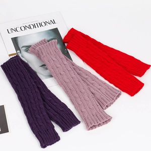Detail of cable knit arm warmers in deep purple, light purple and red colors