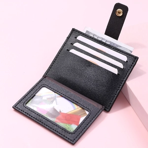 Detail of black litchi leather card holder with three card slots and clear ID window