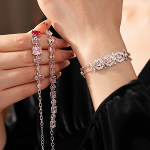 Macro detail of French vintage silver bracelets with pink and red zircon gemstones
