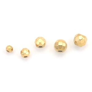Close-up of five faceted gold-plated stainless steel spacer beads on white background