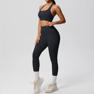 Detail of high-waist black yoga leggings and compression sports bra for gym training