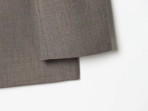 Macro detail of high-quality dark taupe woven fabric for suits with precise stitching