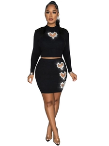 Women's black knit two-piece set with rhinestone heart cutout crop top and mini skirt