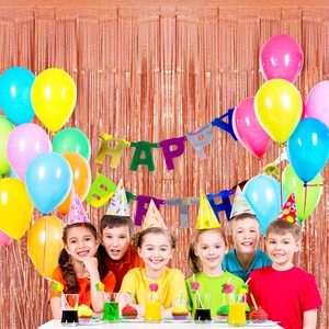 Kids celebrating with happy birthday banner, rose gold fringe curtain and balloons