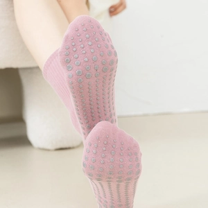 Pink yoga socks with gray anti-slip silicone grips on the sole for pilates and fitness