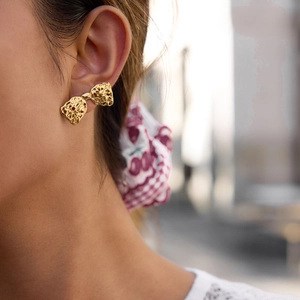 Elegant gold bow earrings with hollow lava texture for women in a modern vintage style