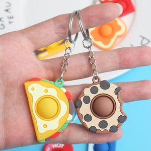 Squeeze toy keychain set featuring taco and bitten cookie designs on metal rings