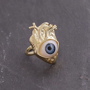 Detailed close-up of 18K gold-plated punk heart ring featuring a realistic blue eye iris