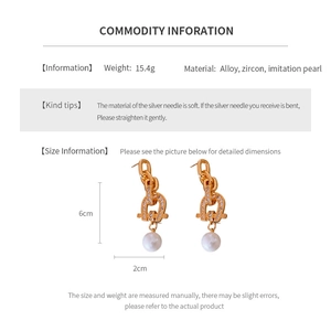 Detailed view of horseshoe tassel earrings with pearls and dimensions 6cm by 2cm