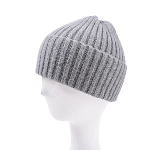 Detail of grey knitted beanie showing ribbed texture and wide fold-over cuff on head form