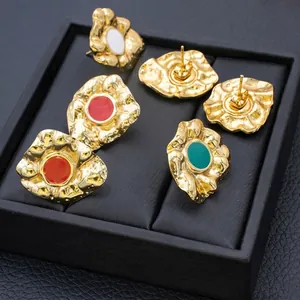 Retro hammered gold heart earrings with colorful enamel inlay on black display