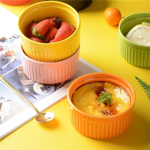 Top view of colorful ceramic heart dishes with vertical stripes for desserts and sauces