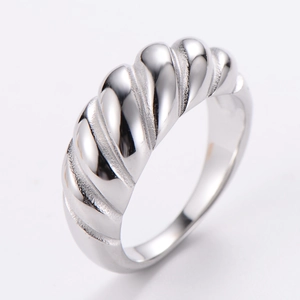 Macro detail of silver stainless steel ring with elegant French tire tread texture