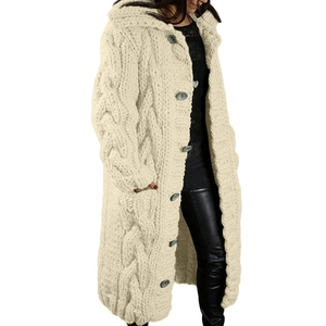 Detail of cable knit pattern and button closure on women's long oversized cardigan sweater
