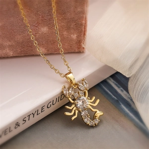 Macro shot of gold-plated scorpion pendant necklace with sparkling zircon crystals