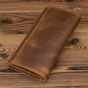 Detailed view of vintage crazy horse leather wallet with precision stitching on wood surface