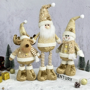 Three plush Christmas figurines including reindeer, Santa, and snowman in gold and beige