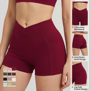 High-waisted crossover yoga shorts in burgundy with side pockets and ruched back