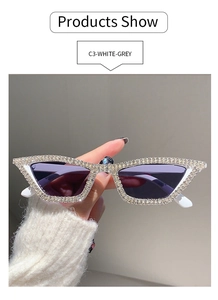 Detail of white cat eye sunglasses with rhinestones and purple gradient lenses