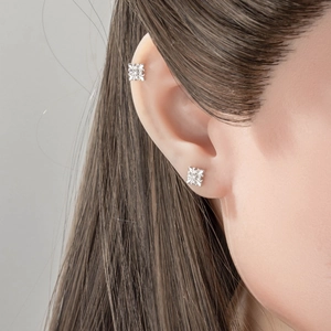 Silver iris cross flower stud earrings worn on earlobe and cartilage for women